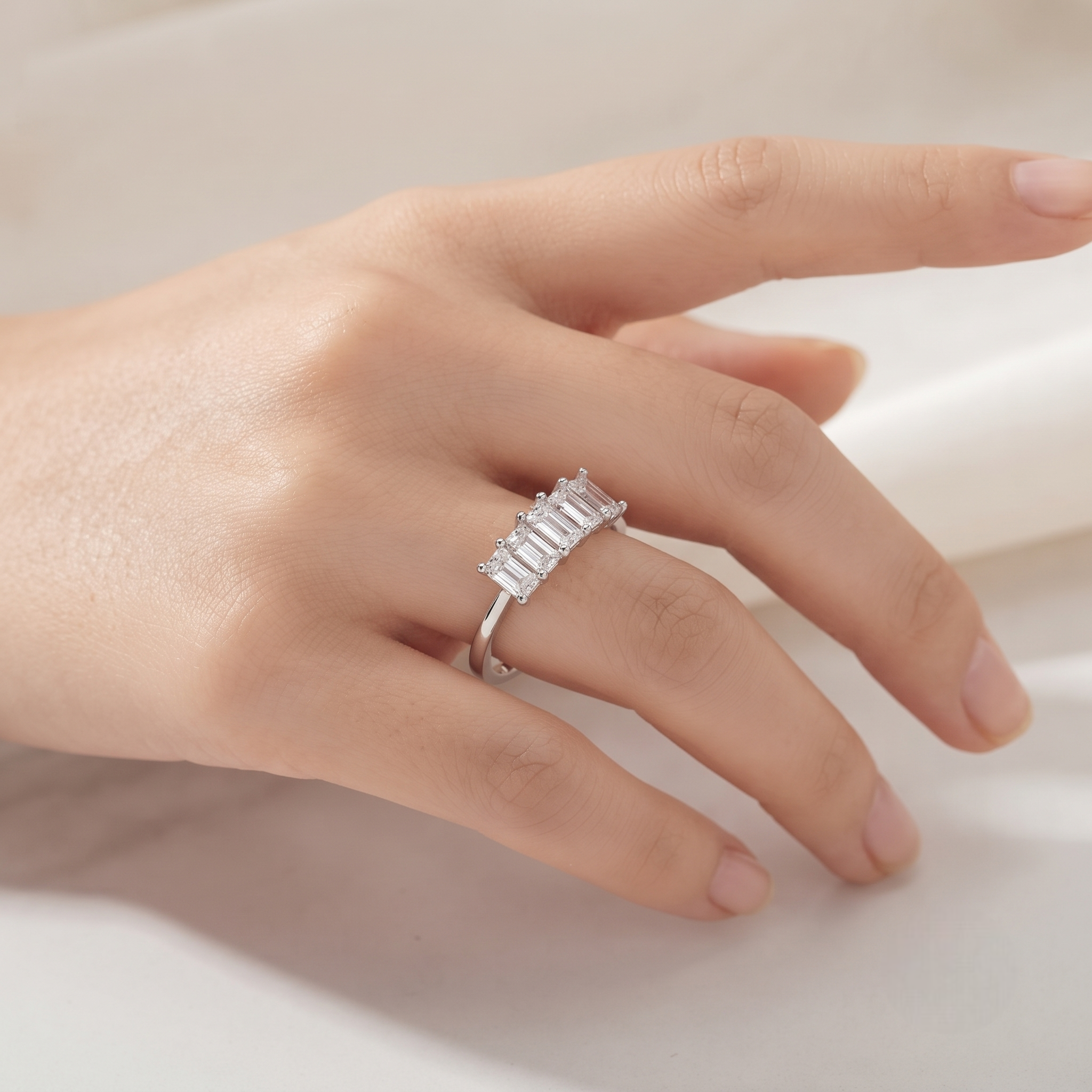 925 Sterling Silver Three-Stone Emerald Cut Cubic Zirconia Ring for Women on Black Stone Display