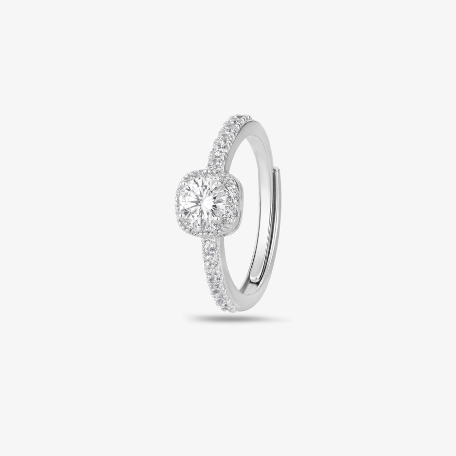 925 sterling silver halo engagement ring with a round brilliant-cut center stone and pavé band, worn on a woman's hand against a soft white background.